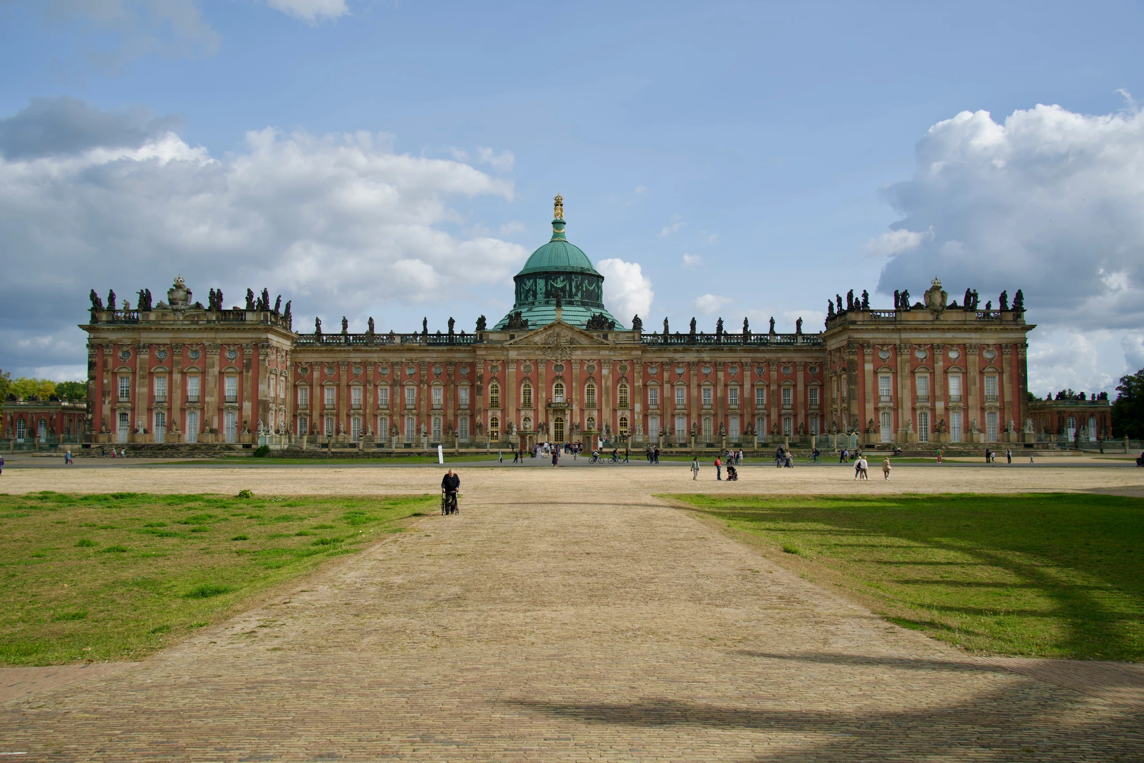 a large building with people walking around it