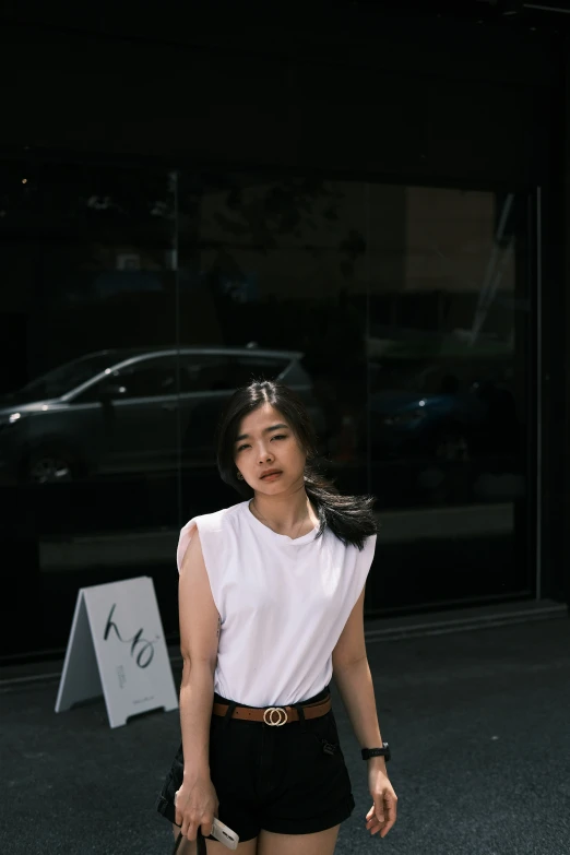 a woman standing next to a car in the parking lot