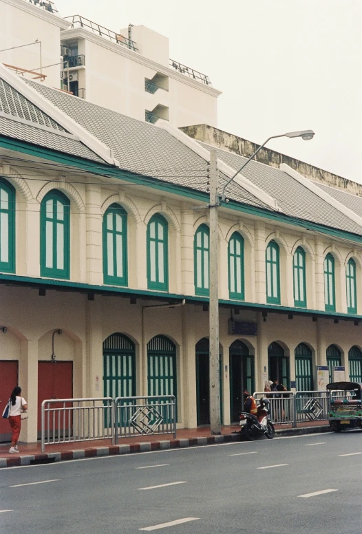 an old building is next to a road with traffic