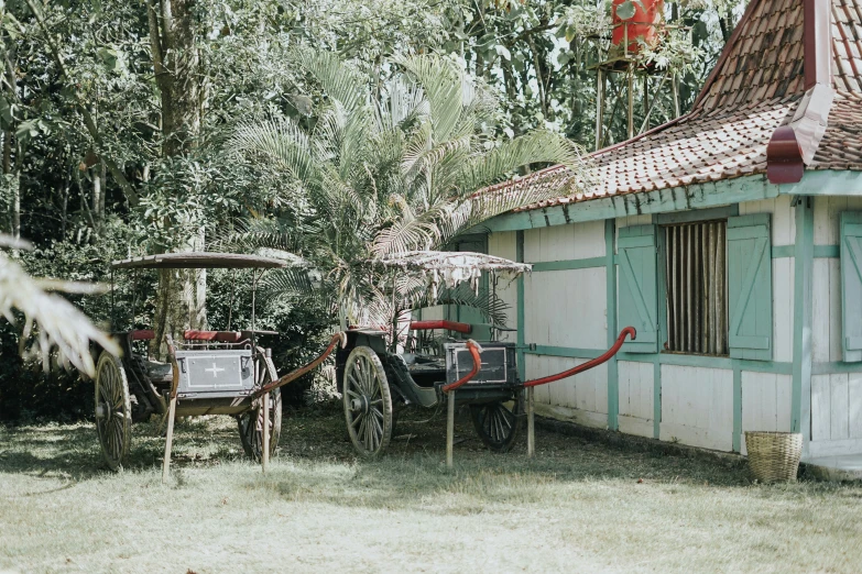 a rustic farm house with horses pulling carriages