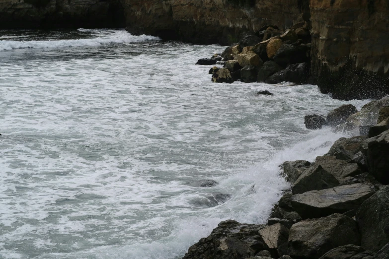 the waves break over the rocks and create interesting patterns