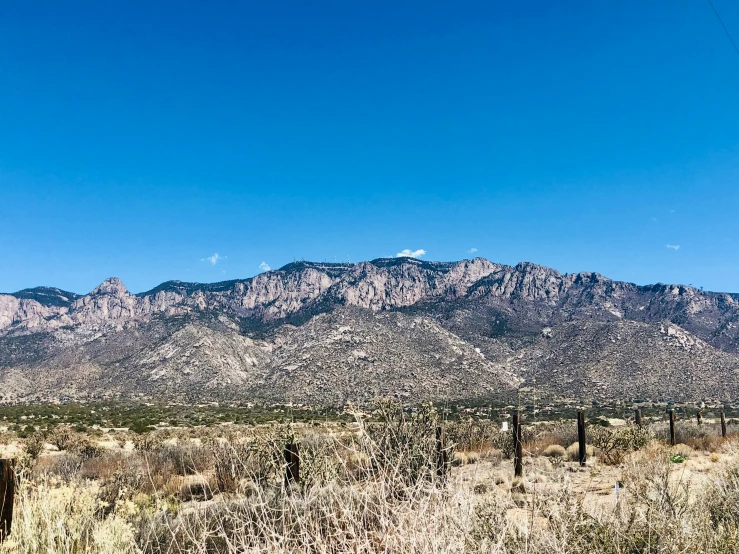 view of the mountains with a fence in front