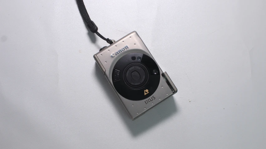 a camera on a cord attached to a white surface