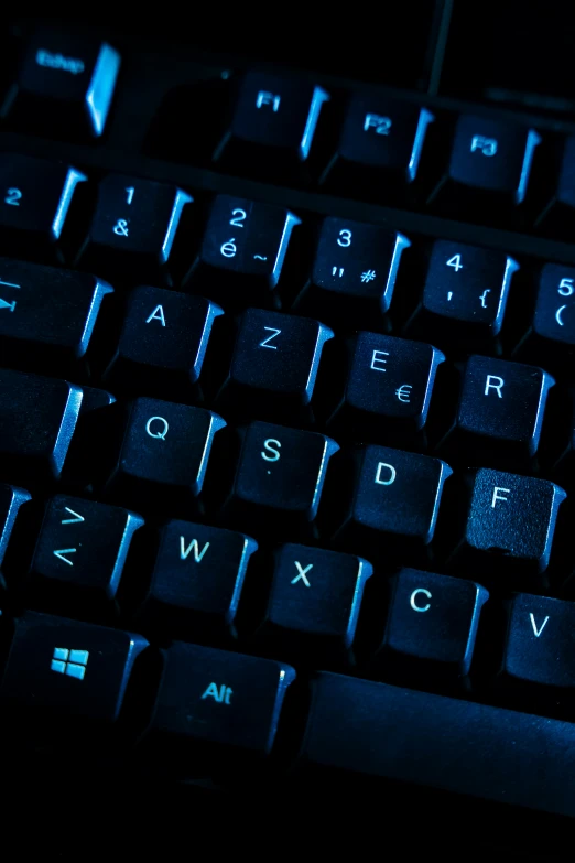 a keyboard is glowing in the dark on a table