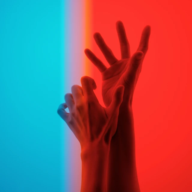 two hands in front of the rainbow, a red - blue - and green background