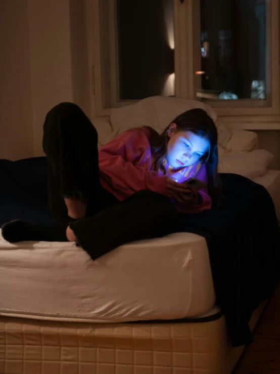 a woman on a bed with a laptop computer