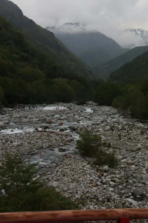 mountains and a mountain river next to a highway