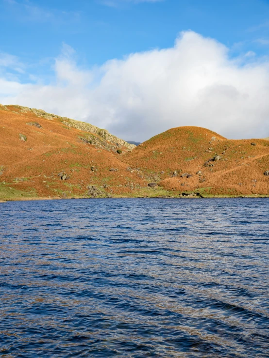 a boat out on the water near some hills