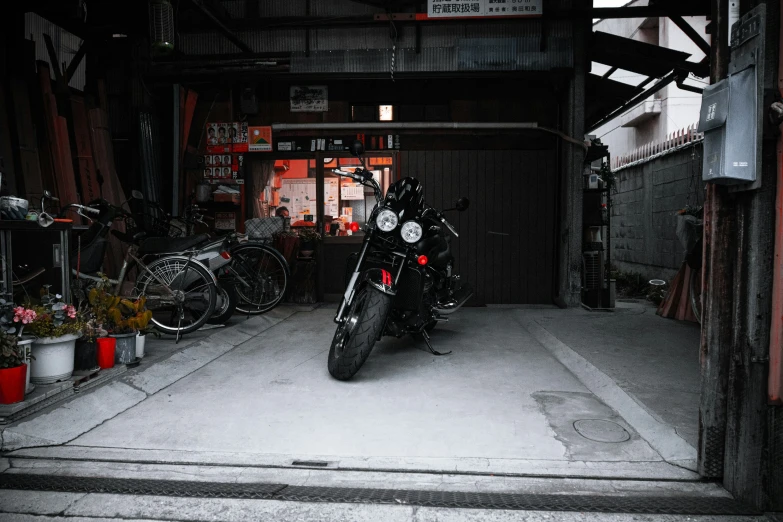 a motorcycle sits parked inside a building with lots of bikes