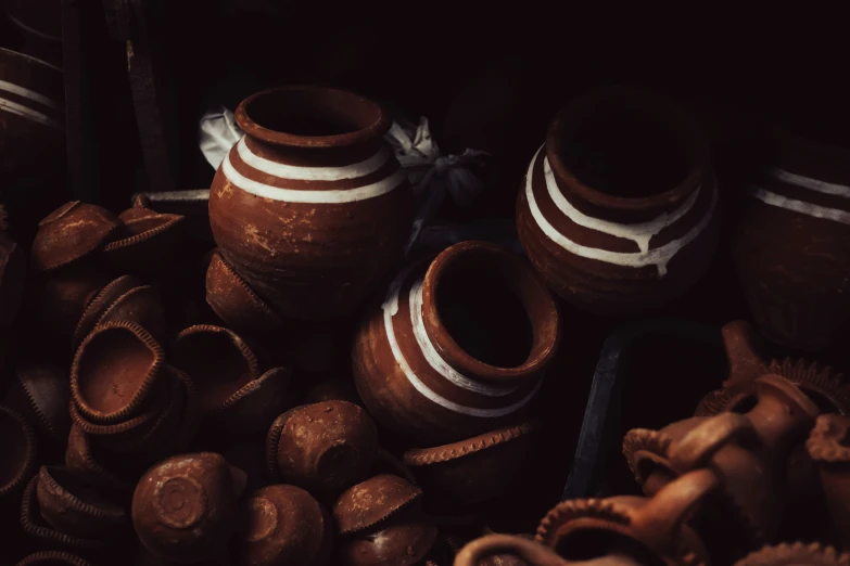 many ceramic pots are sitting on the floor