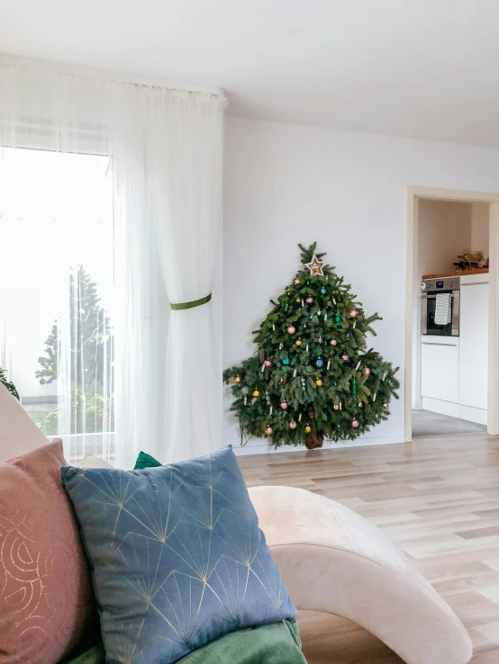 living room with white furniture and christmas tree