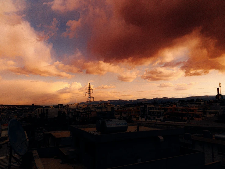 a dark cloudy sky with power lines at sunset