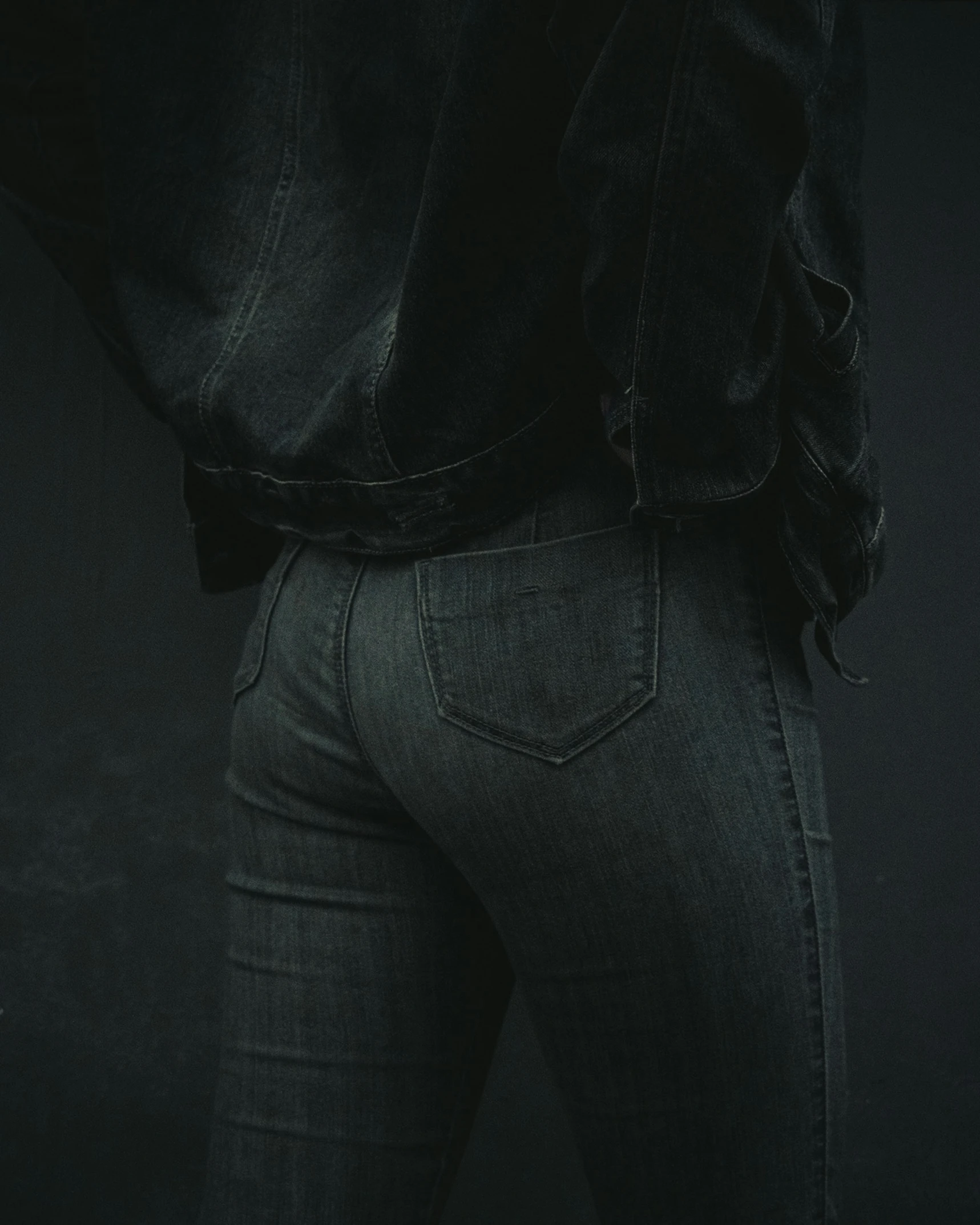 the bottom of a persons jeans is dark