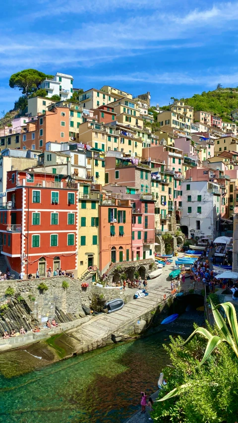 colorful city perched on the edge of water and a mountain