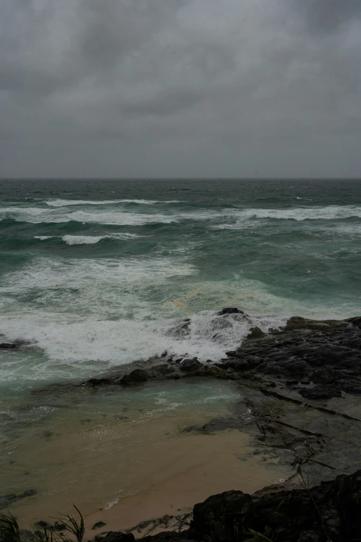 the ocean is crashing on rocks and waves