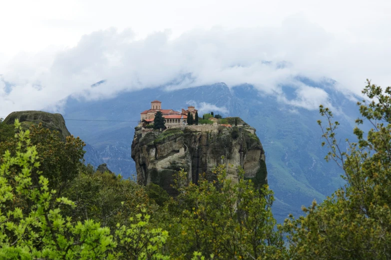 a tall building in the middle of a rocky area