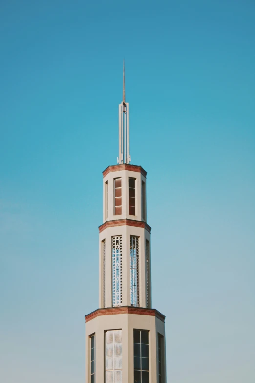 a clock tower with a wind indicator on top