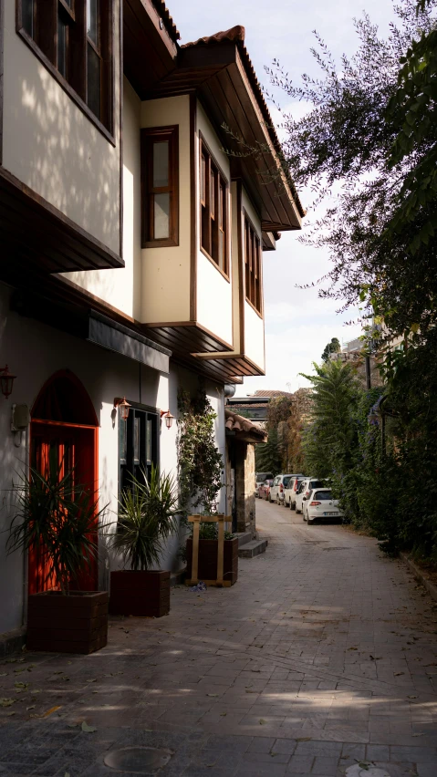 an empty paved sidewalk near the houses