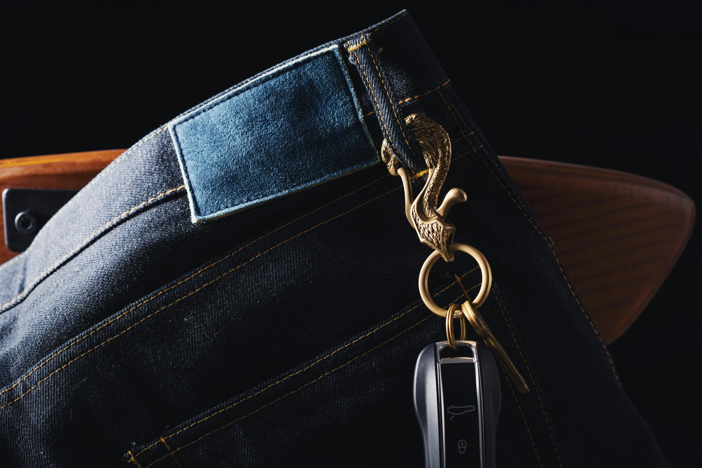 a close up of a pair of jeans with a gold metal zipper