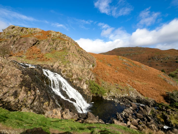 a mountain with a waterfall cascading from it