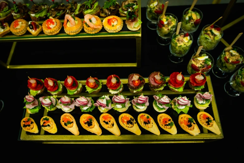 several plates of appetizers and condiments are arranged in rows