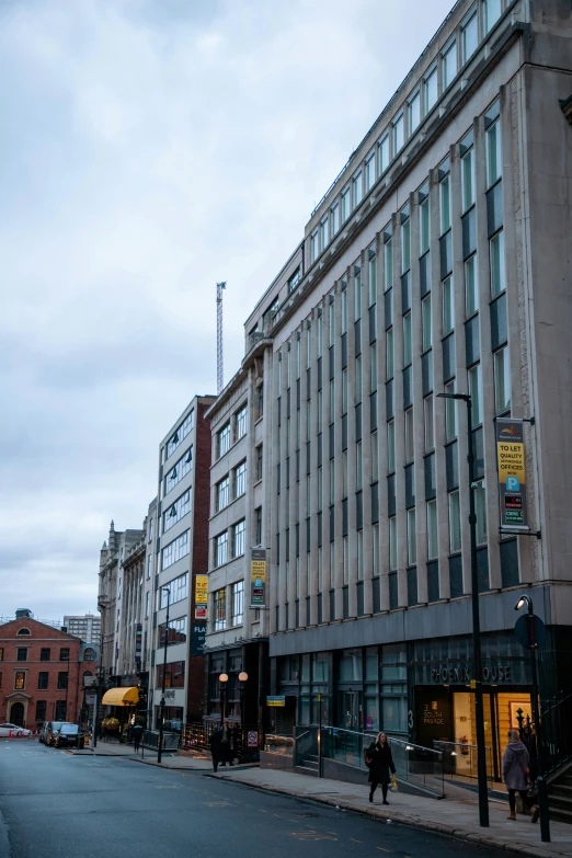 the building with many windows is next to a road