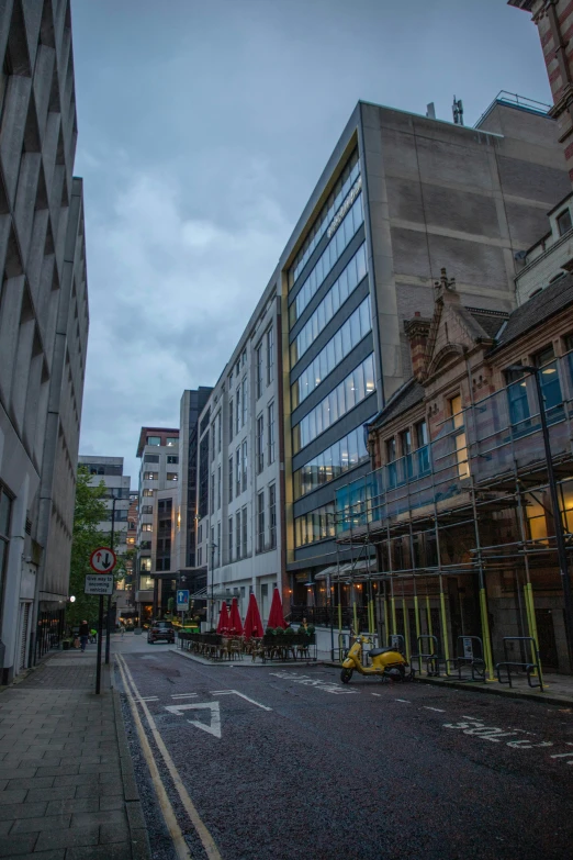 an old fashion street with buildings and a few people