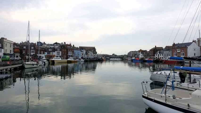 boats are parked in the water in front of houses