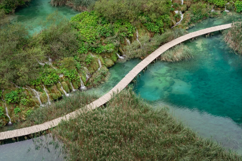 this po shows a man - made bridge with a beautiful river in it