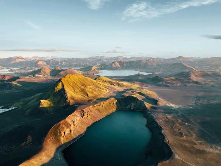 a landscape showing several hills and lakes in the distance