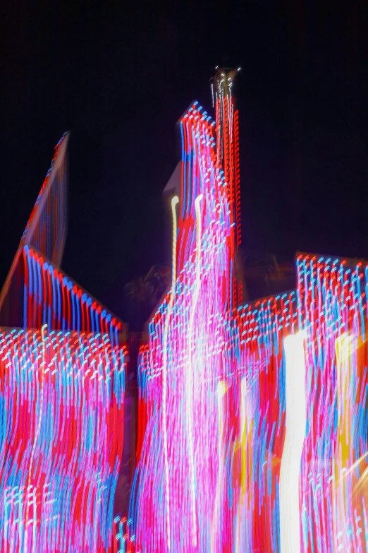 a motion blur pograph shows colorful buildings in the background