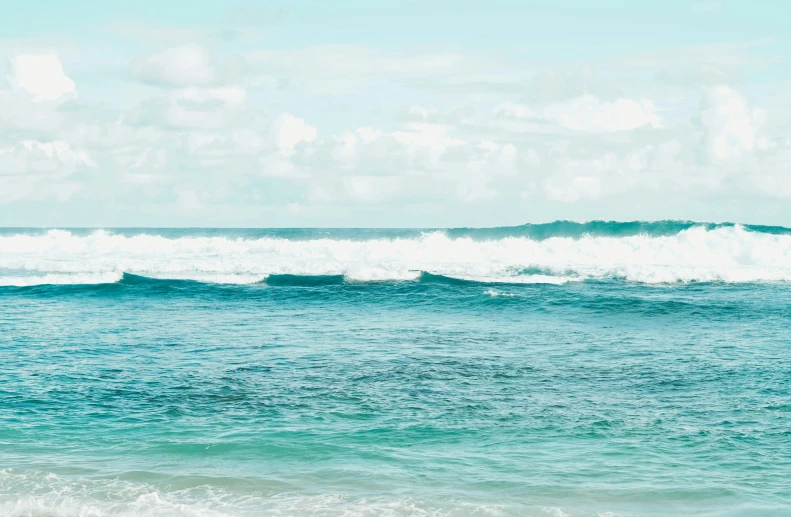 a body of water with many small waves coming up