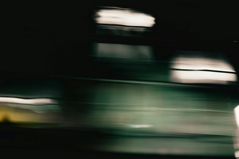 blurry pograph of bus from car window at night