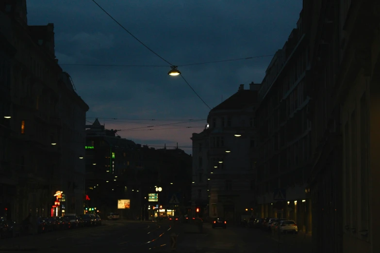 there are cars and people walking down this street