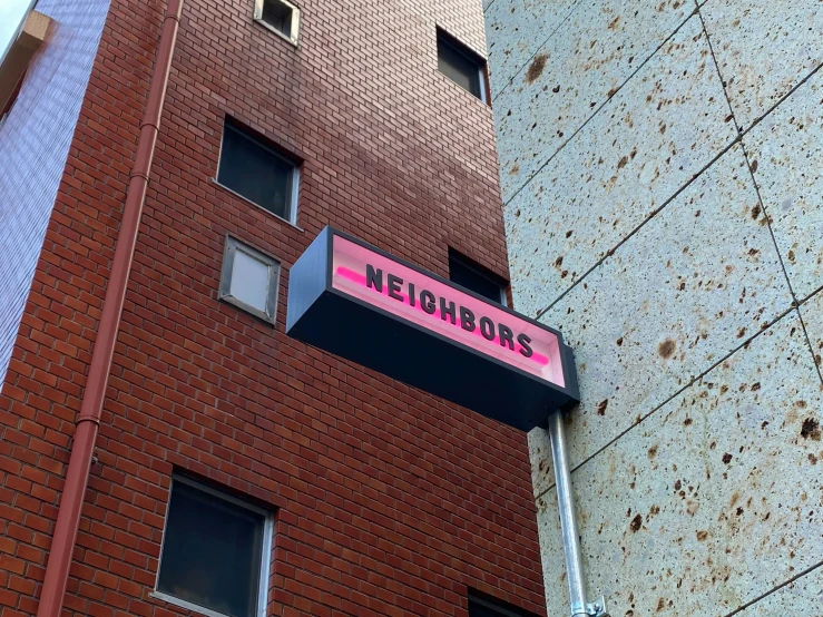 some very tall brick buildings with windows and a sign