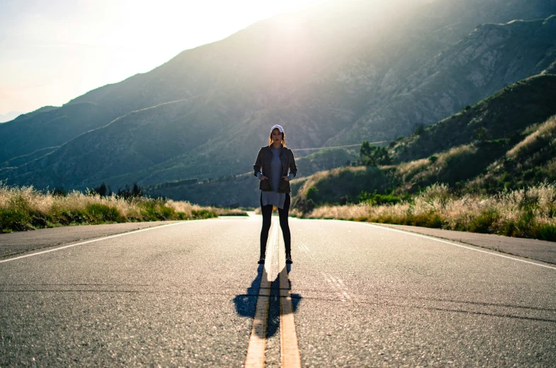 the woman is riding her skateboard down the road