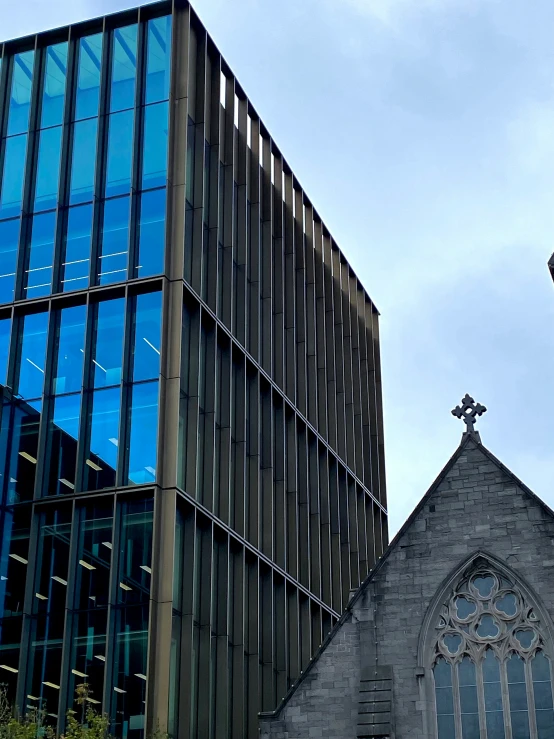 a church is next to a tall tower and steeple