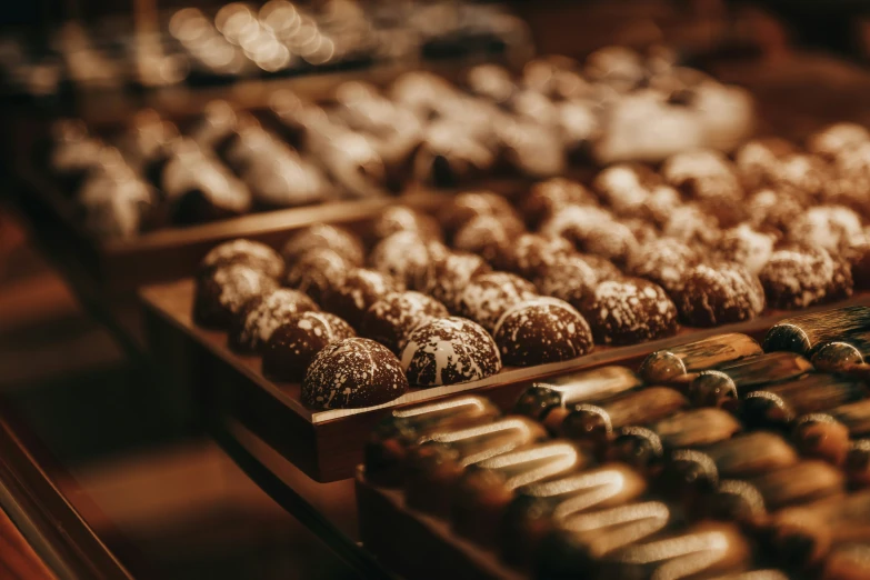 two rows of different types of pastries in a display