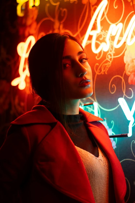 a woman is standing in front of neon signs