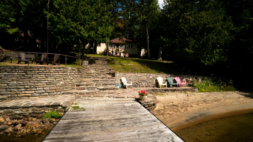 a dock is surrounded by stone steps in front of a lake