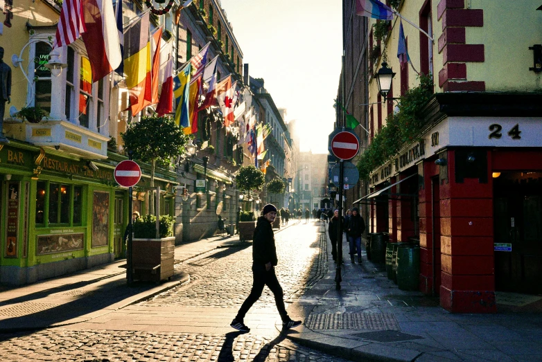 people on a street in front of many buildings