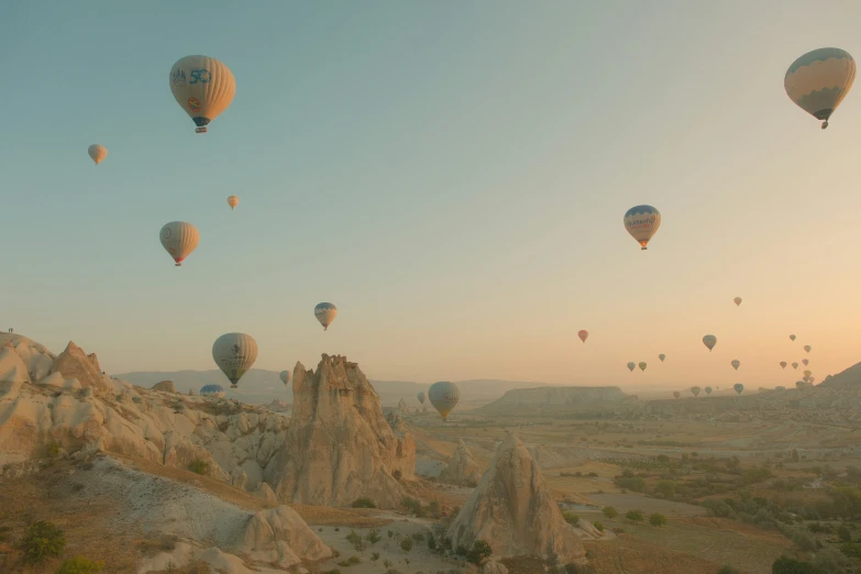 the  air balloons are flying high in the sky