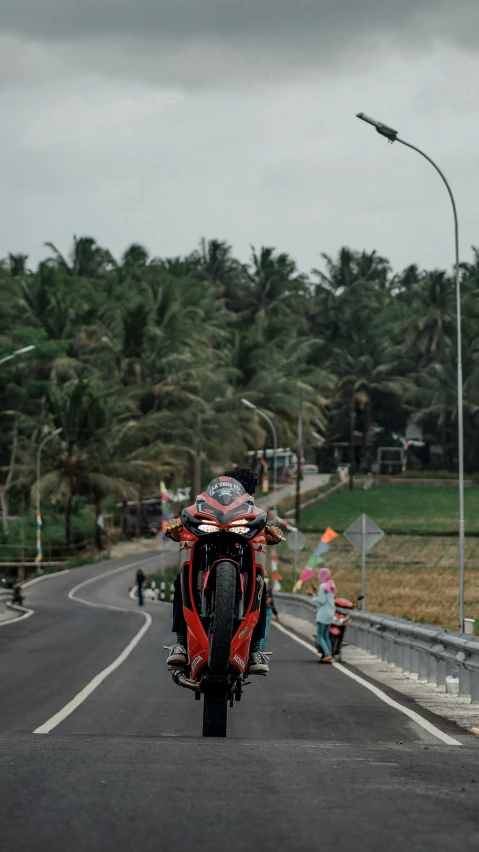 a person on a red motorcycle on a street