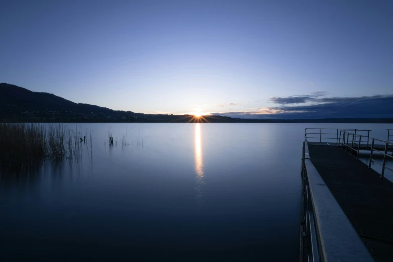 a boat in a lake at sunset