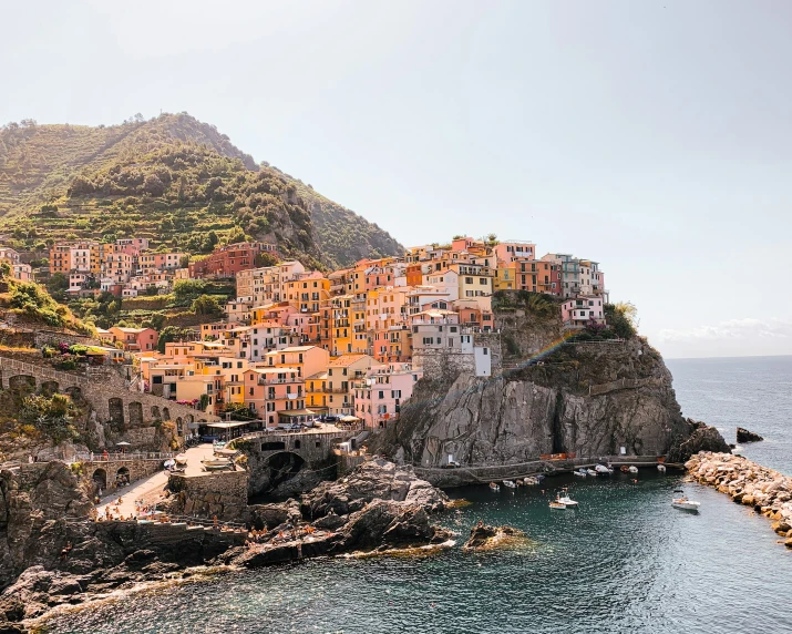 a beach with several small houses in the mountains