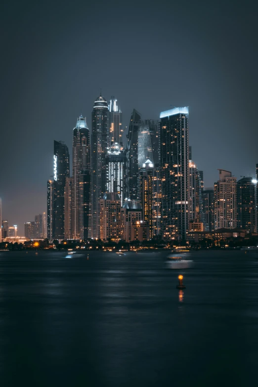 a city skyline is seen with skyscrs lit up