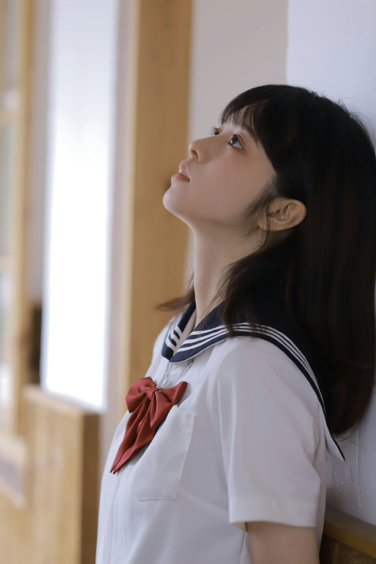 a girl with a white shirt and tie is wearing a sailor uniform