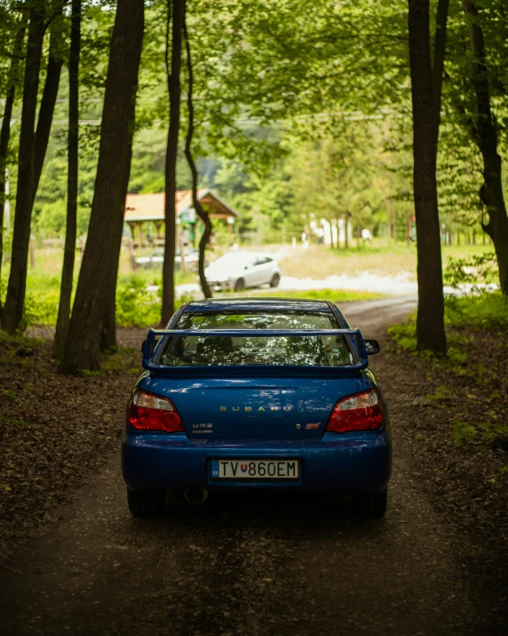 a car sitting in the middle of a forest