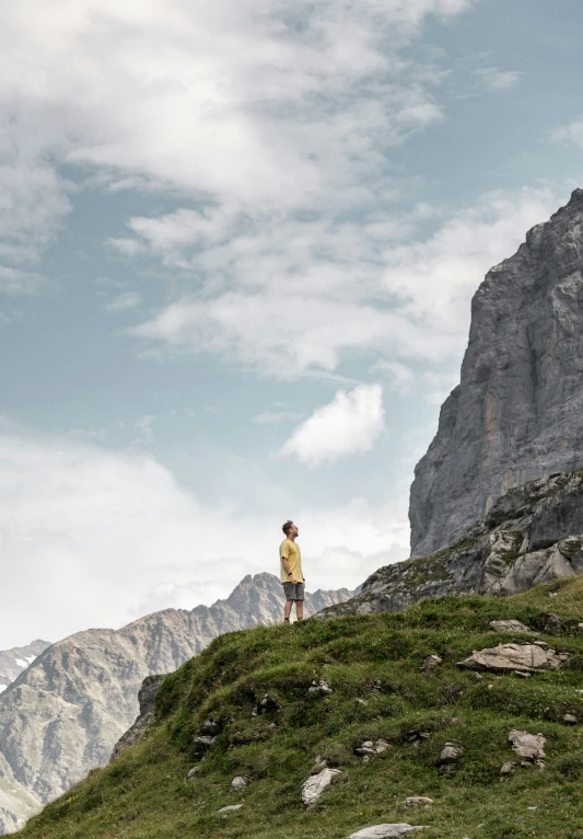 a person that is standing on a hill top