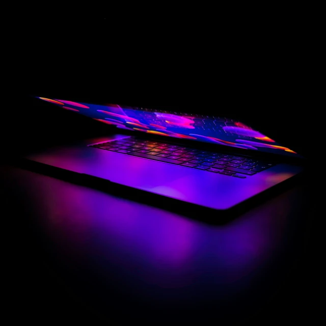 an illuminated laptop and its protective case